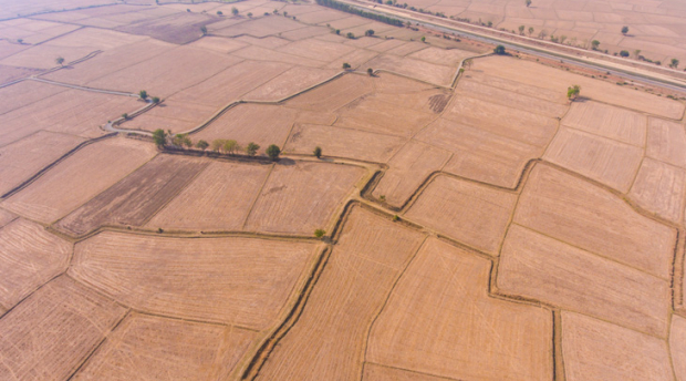 An aerial photo of dry farmland in various plots